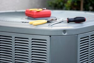 tools on outdoor air conditioning unit during residential AC repair service