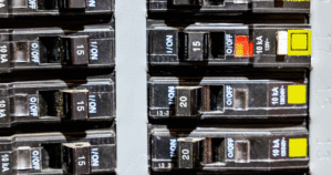 electrical circuit breaker panel with tripped breaker switch