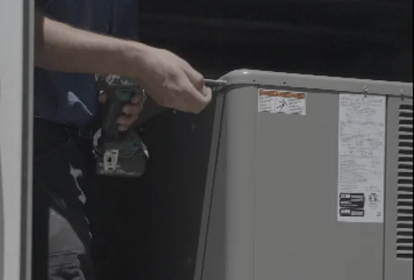 HVAC technician performing maintenance on residential heating and cooling unit