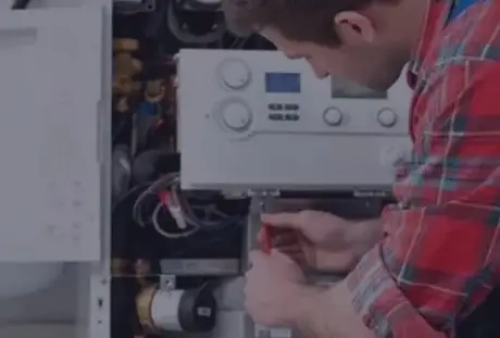 HVAC technician repairing a residential heating system boiler